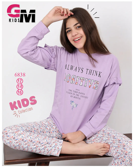 Girl wearing a purple long-sleeve shirt and patterned pants with 'GM Kids' branding.