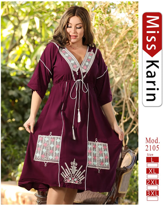 Woman wearing a burgundy dress with embroidery, standing outdoors with 'Miss Karin' branding.