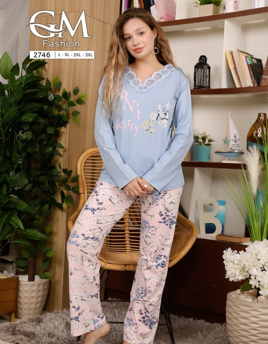 Woman wearing a light blue sweater and floral pants sitting in a chair with 'GM Fashion' branding.