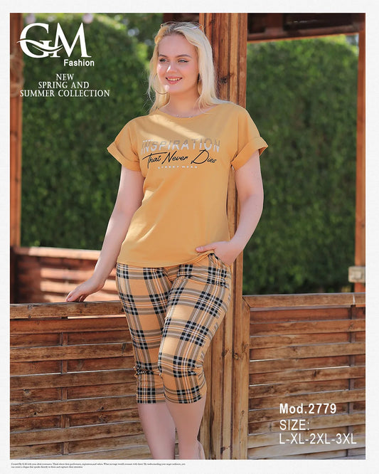 Woman wearing a yellow t-shirt and plaid pants standing outdoors with 'GM Fashion' branding.