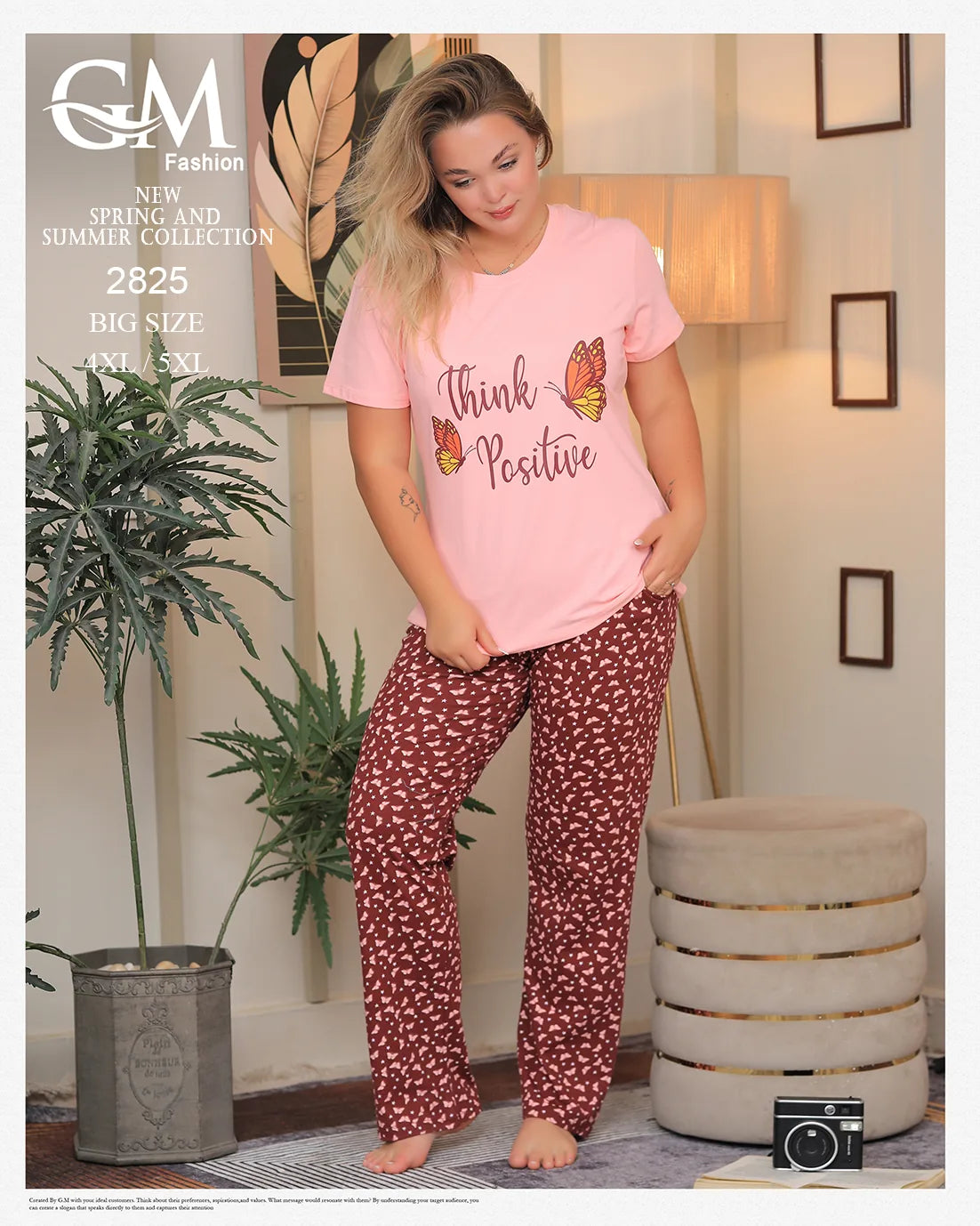 Woman wearing a pink 'Think Positive' shirt and red patterned pants in a room with decor elements.