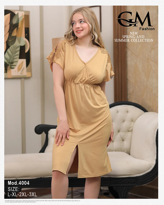 Woman wearing a yellow dress with ruffled sleeves in a room with a sofa and decorative wall art.