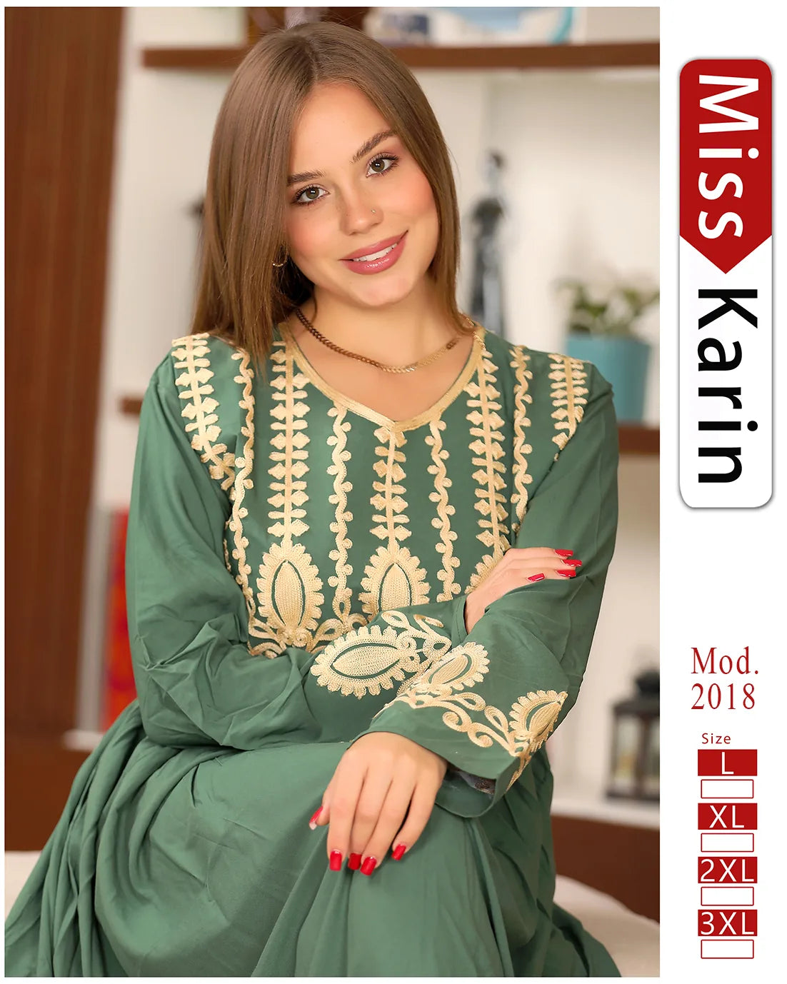 Woman wearing a green dress with gold embroidery, sitting indoors.