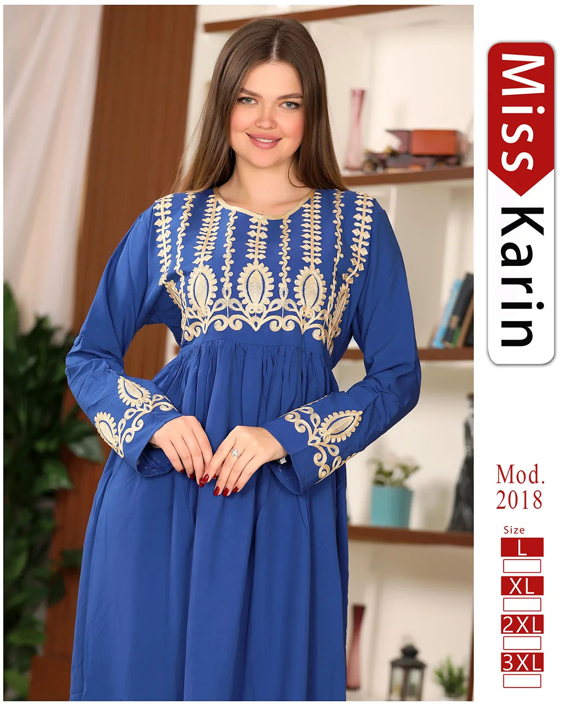 Woman wearing a blue dress with gold embroidery, standing indoors.