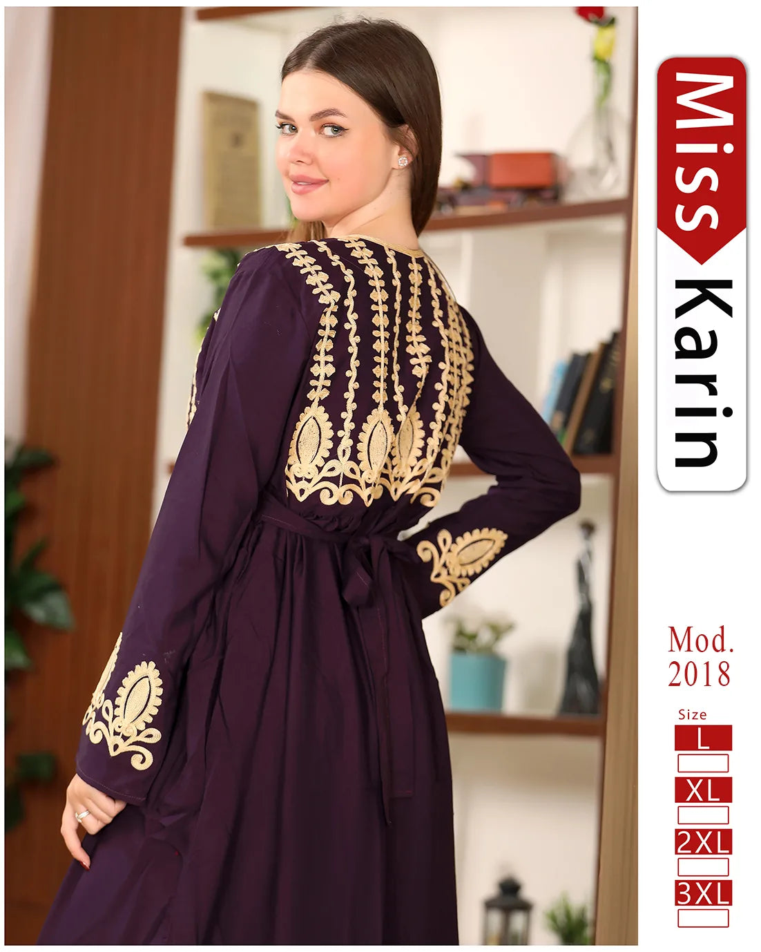 Woman wearing a purple dress with gold embroidery, standing in a room with a blurred background.