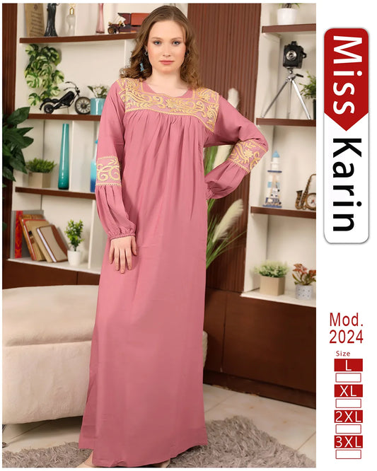 Woman wearing a pink dress with gold embroidery in a room setting, featuring 'Miss Karin' branding.