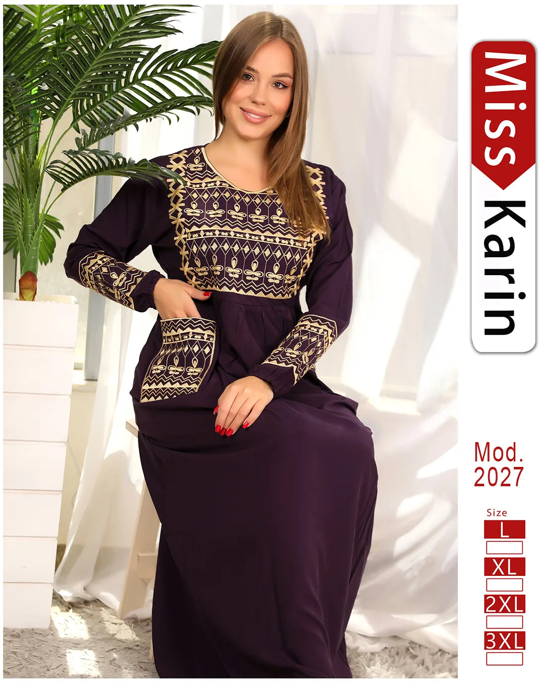 Woman wearing a dark purple dress with gold patterns, sitting indoors with plants and a white curtain.