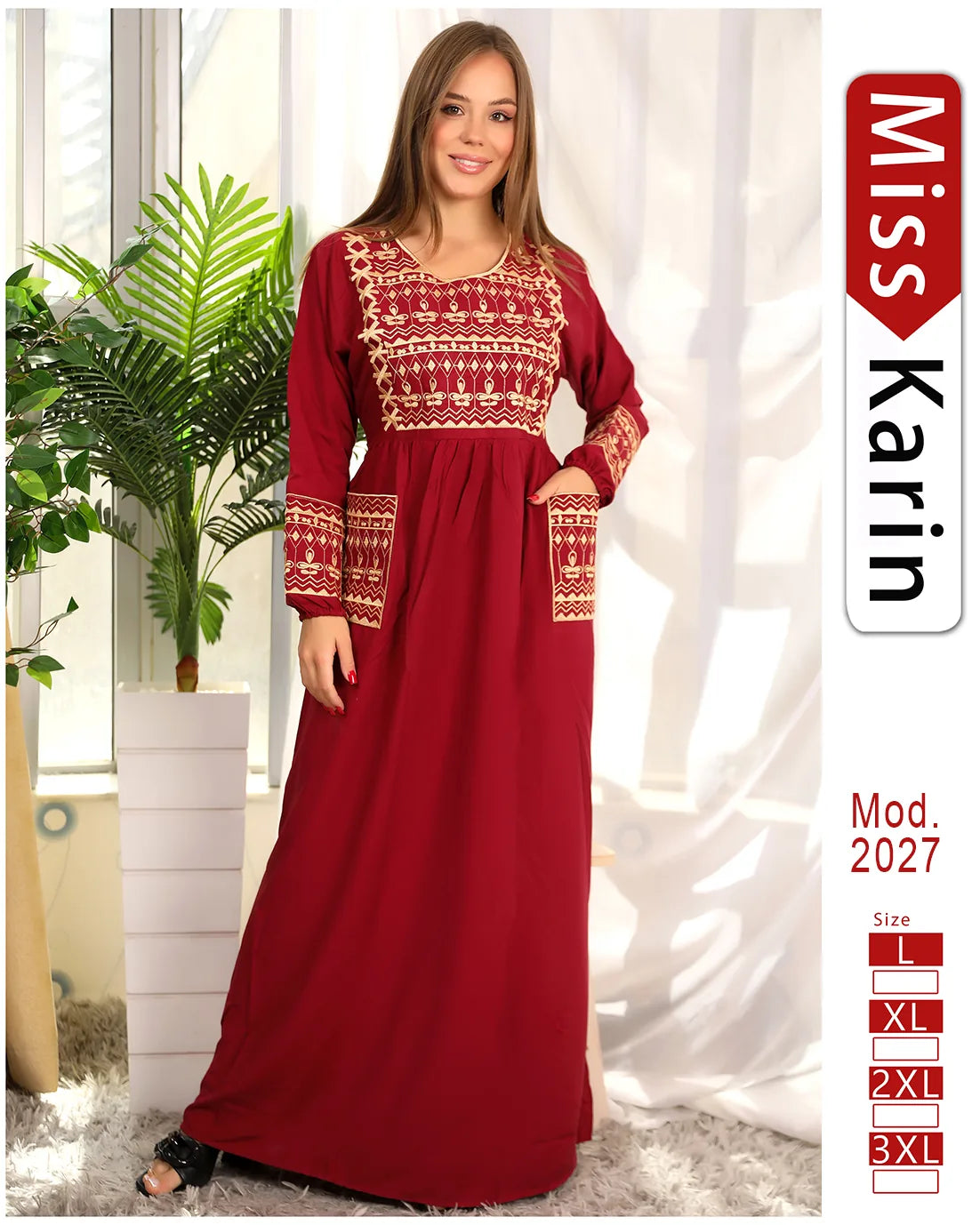 Woman wearing a red dress with white patterns in a room with plants and curtains.
