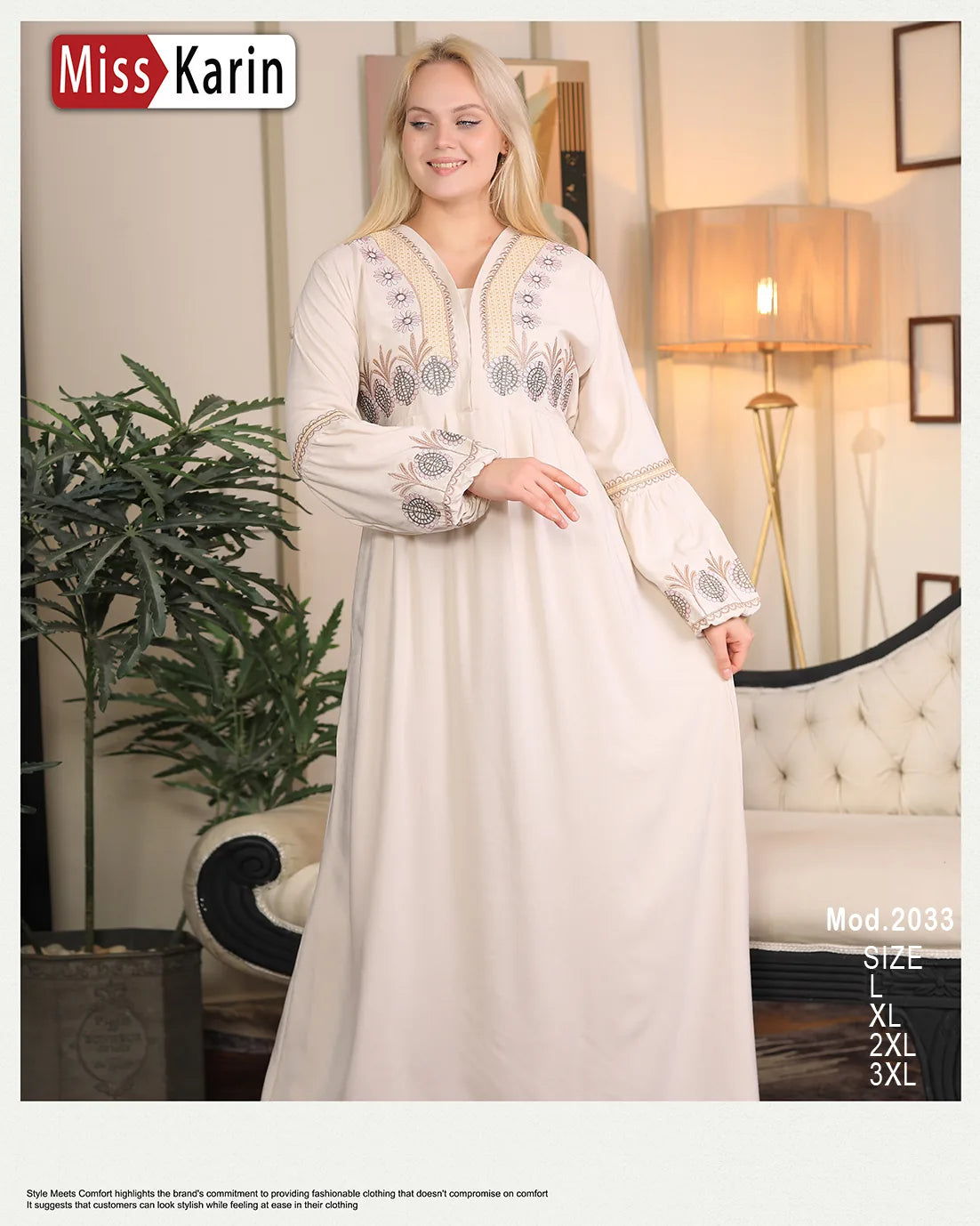 Woman wearing a white embroidered dress in a room with a lamp and plant.