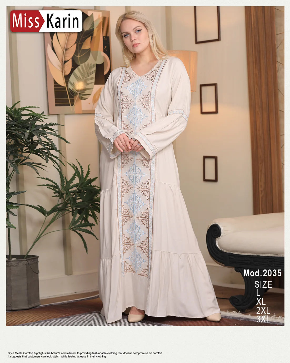 Woman wearing a long, embroidered dress in a room with decor elements.