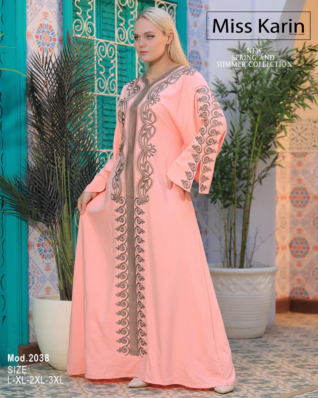 Woman wearing a pink dress with intricate embroidery in a decorative setting, featuring 'Miss Karin' branding.