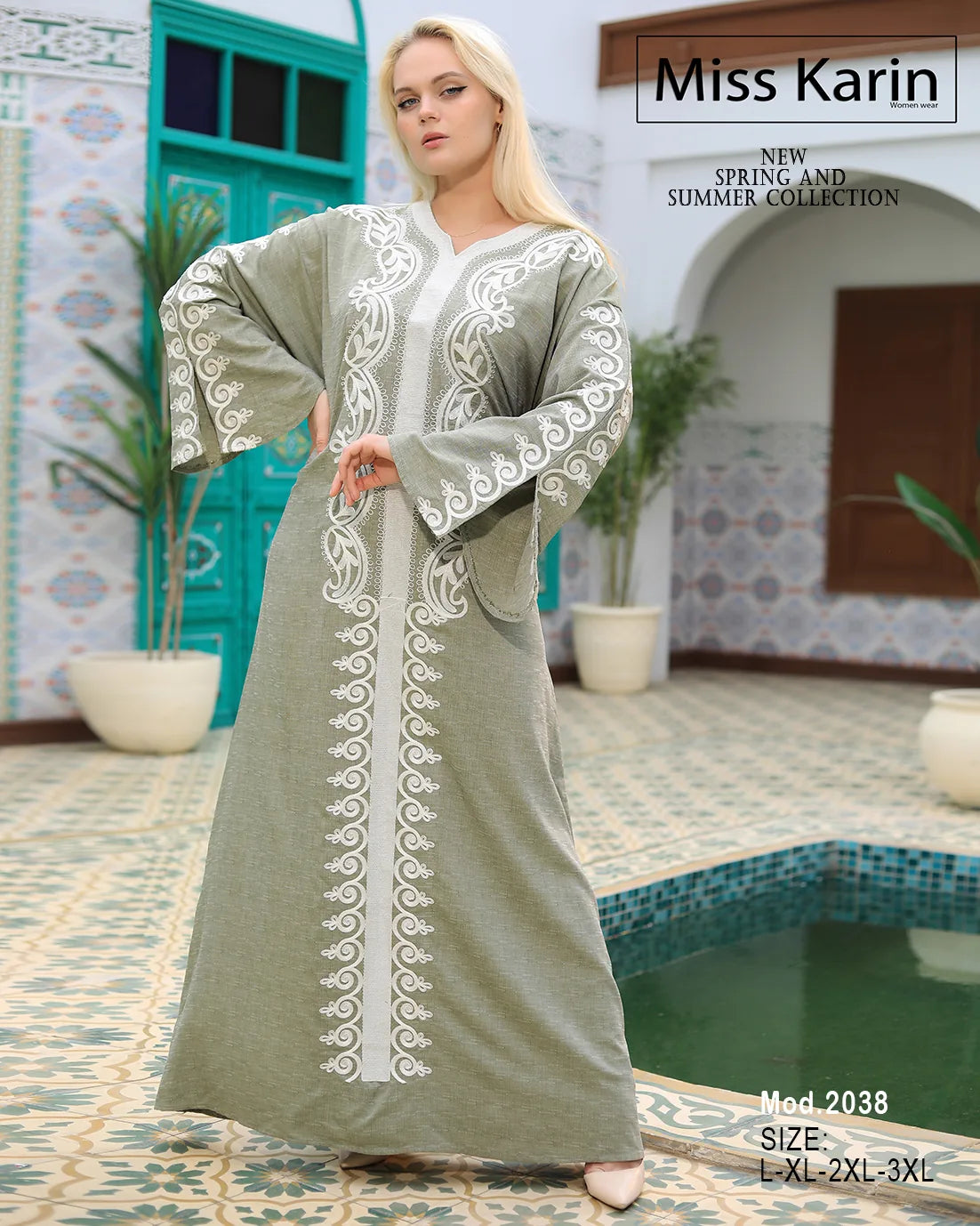 Woman wearing a long, light-colored embroidered dress in a decorative setting with plants and a pool.