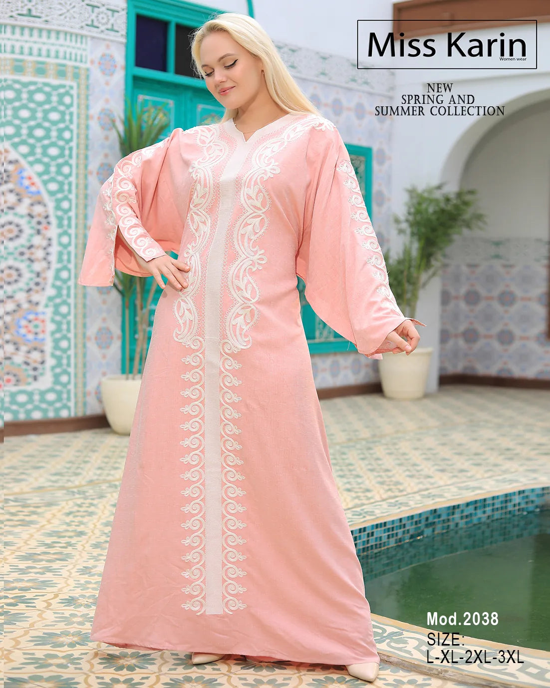 Woman wearing a pink dress with white lace details in a decorative setting.