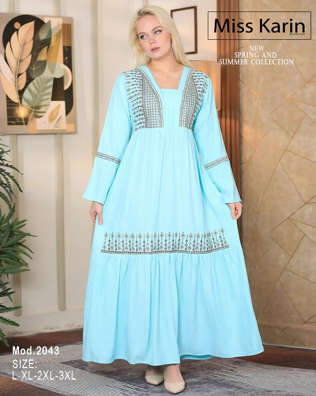 Woman wearing a light blue dress with intricate patterns in a room with decorative elements.