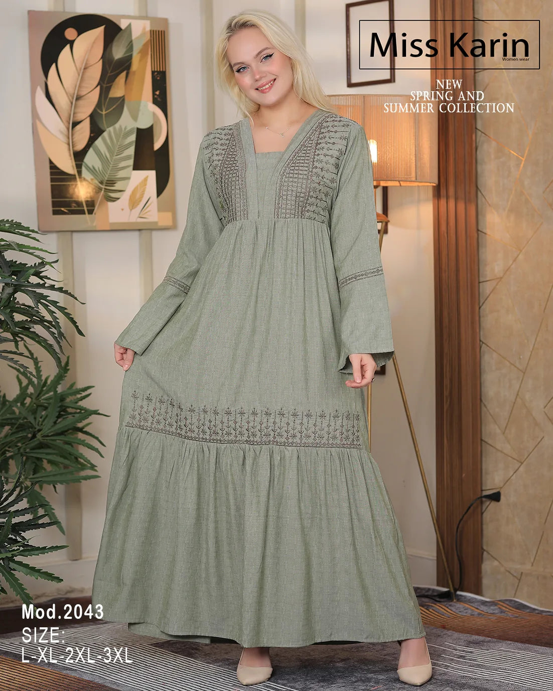 Woman wearing a green dress with intricate detailing, standing indoors with decor elements.
