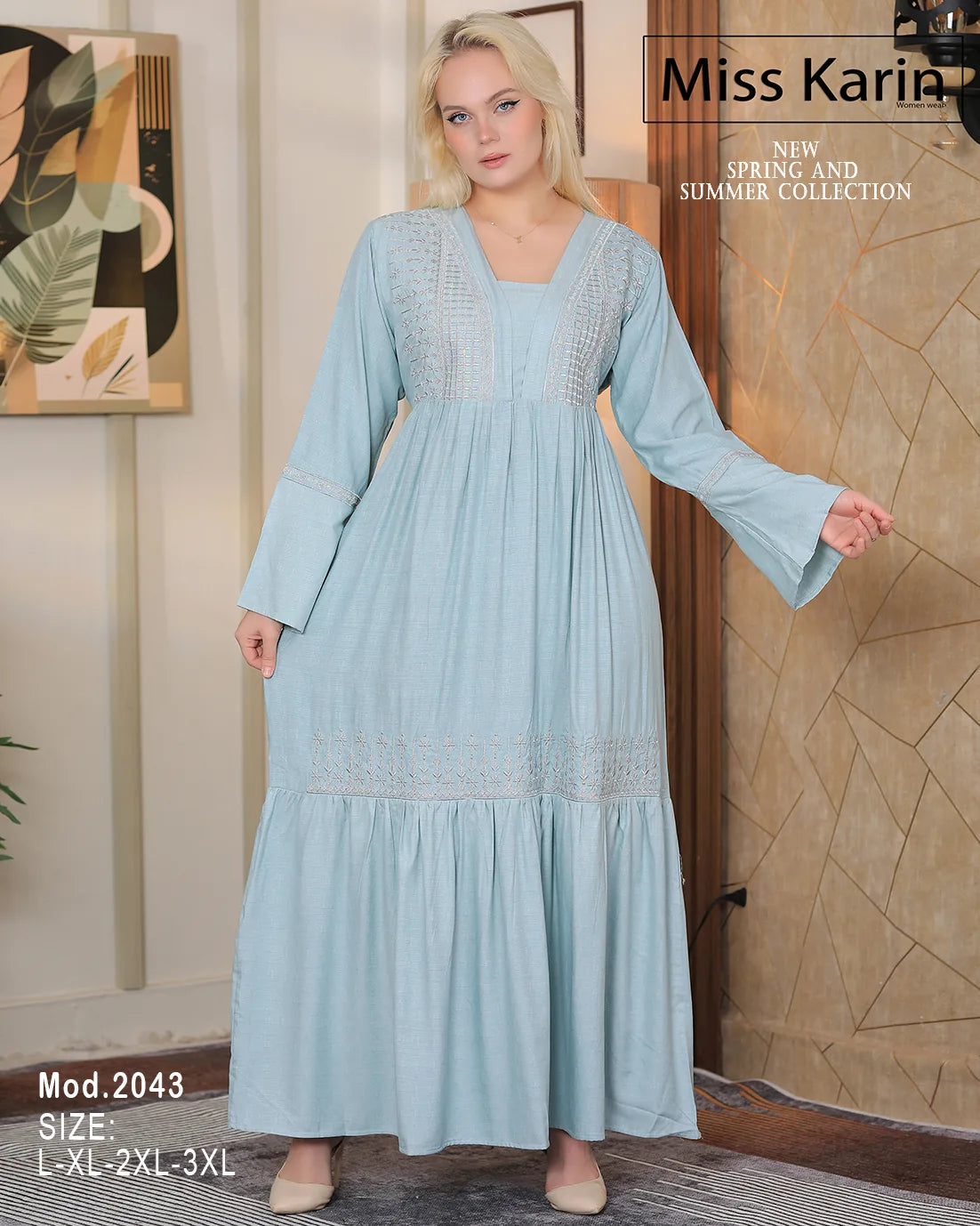 Woman wearing a light blue dress with lace details in a room setting, featuring 'Miss Karin' branding.