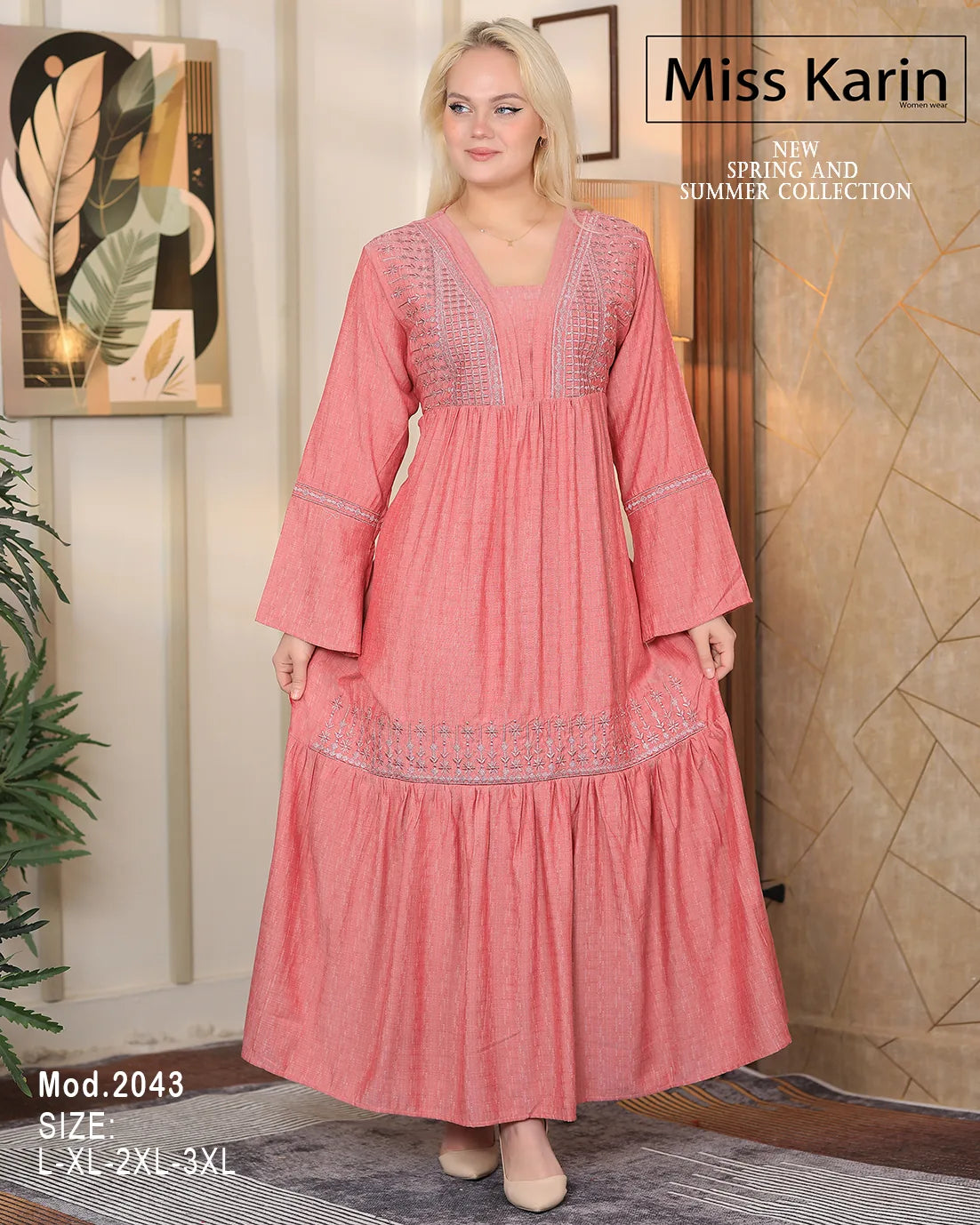 Woman wearing a pink dress with intricate detailing in a room setting, featuring 'Miss Karin' branding.