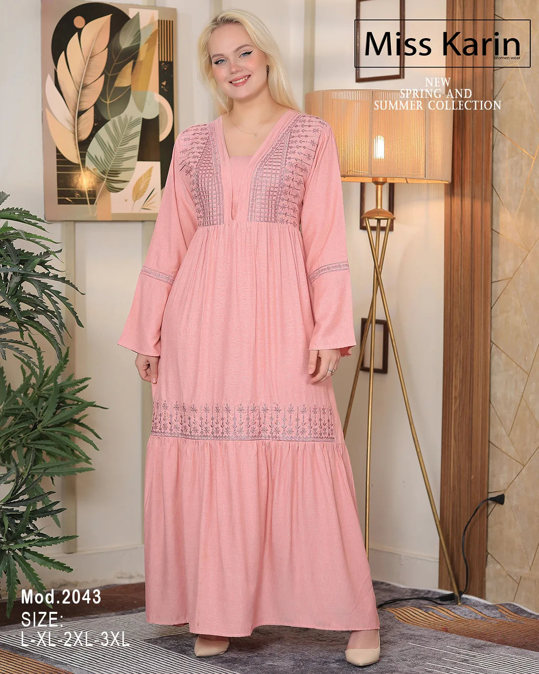 Woman wearing a pink dress with embroidery in a room setting, featuring 'Miss Karin' branding.
