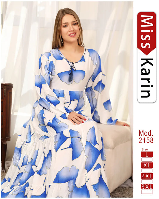 Woman wearing a blue and white floral dress with 'Miss Karin' branding.