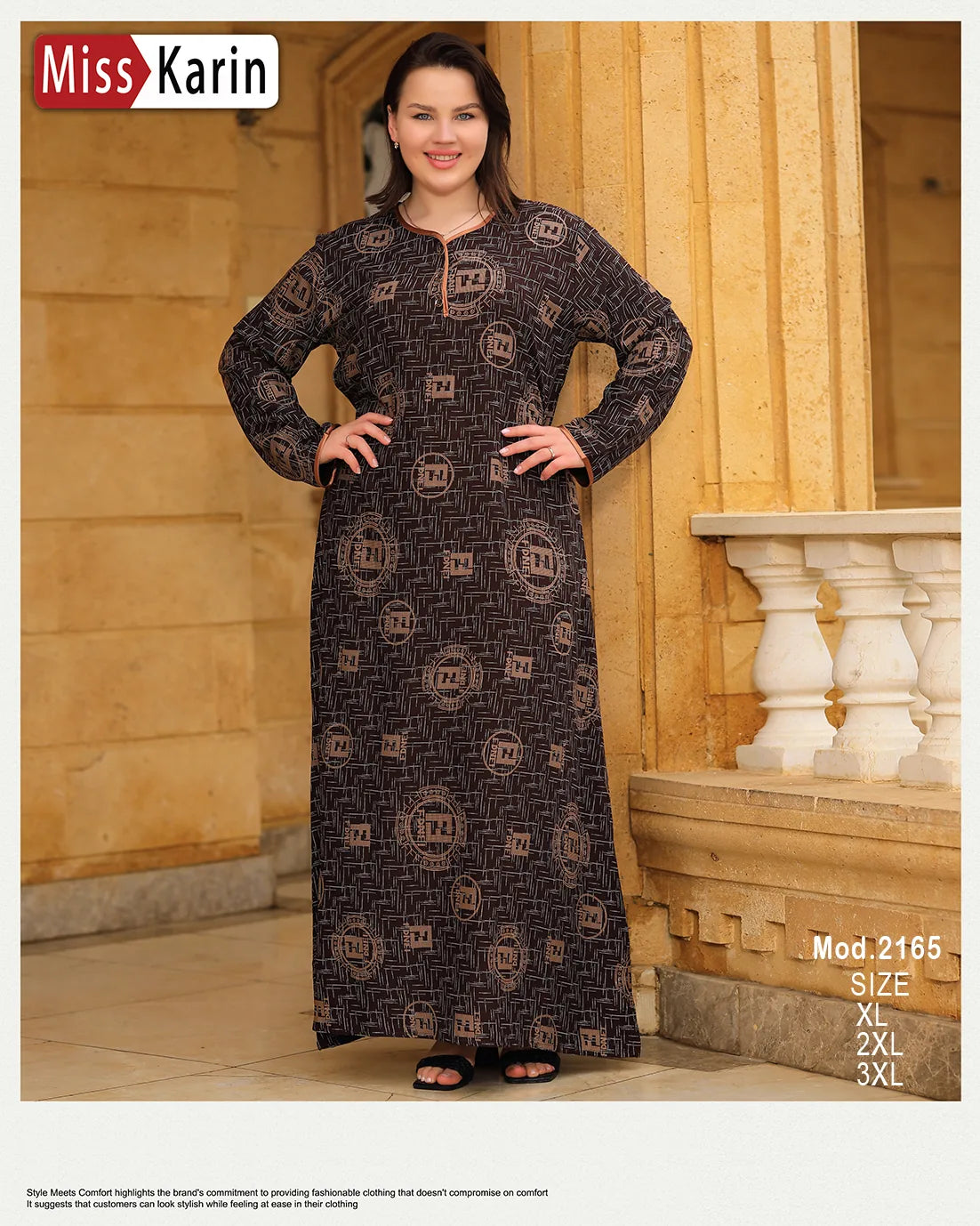 Woman wearing a long dark patterned dress in front of a stone building.