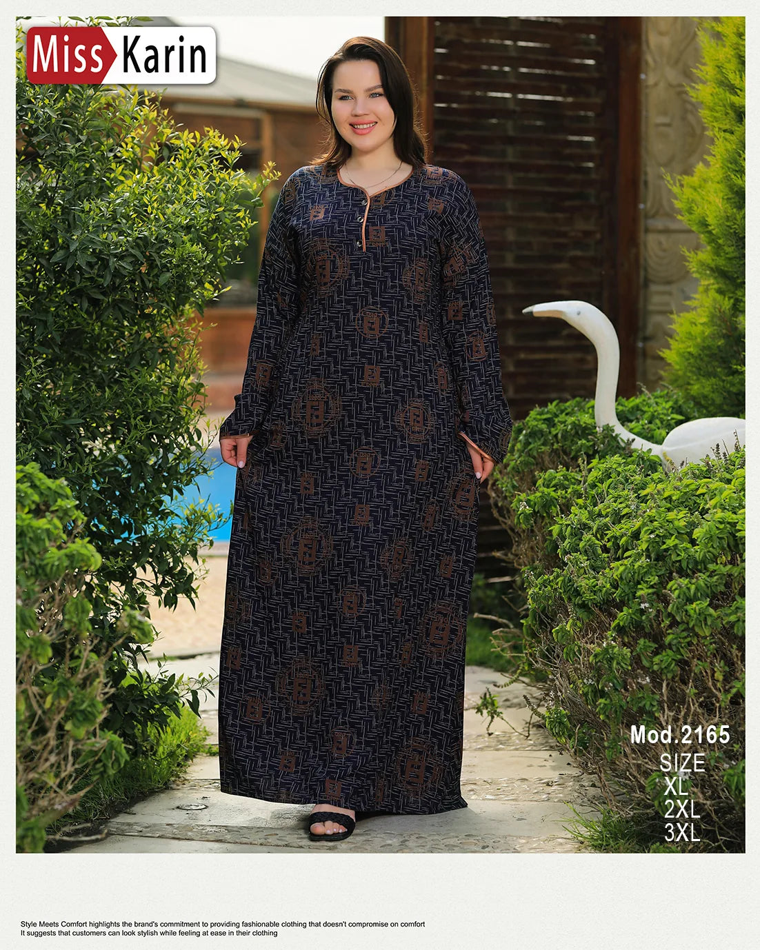 Woman wearing a long dark blue dress with patterns in an outdoor setting with greenery and a swan.