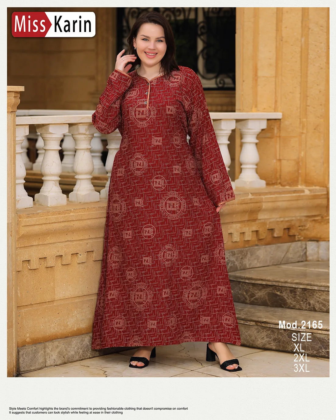 Woman wearing a red patterned dress standing outdoors with architectural background