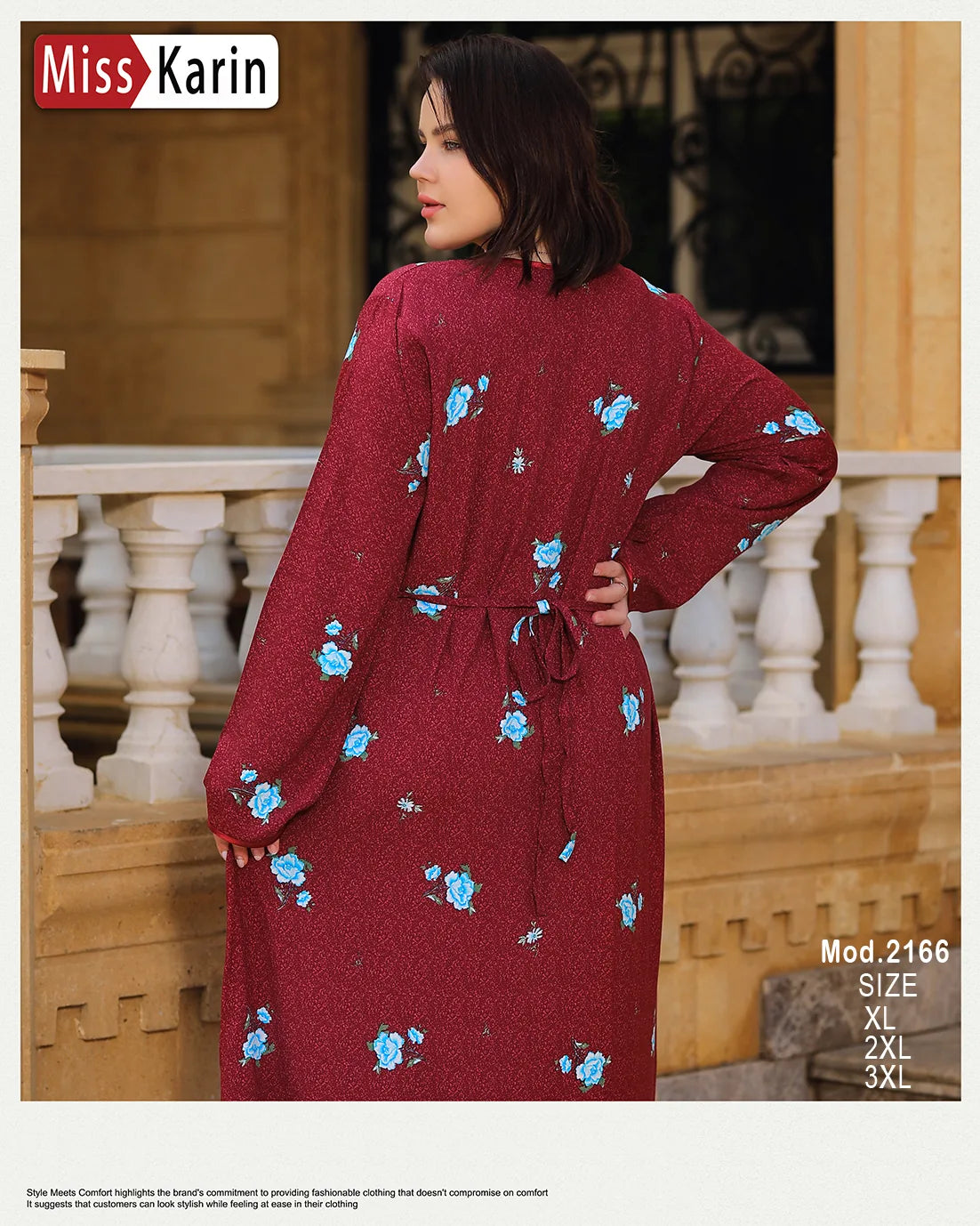 Woman wearing a red dress with blue floral patterns in an outdoor setting.