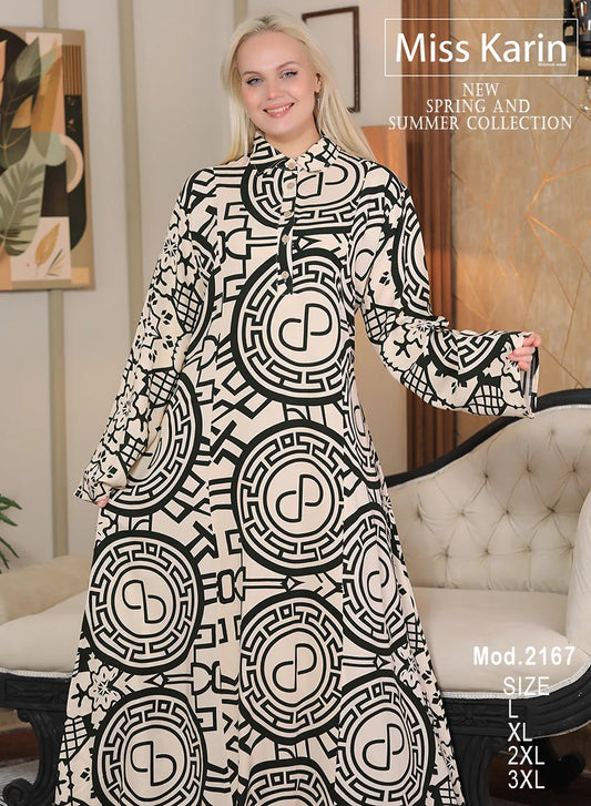 Woman wearing a black and white patterned dress with 'Miss Karin' branding in a room.