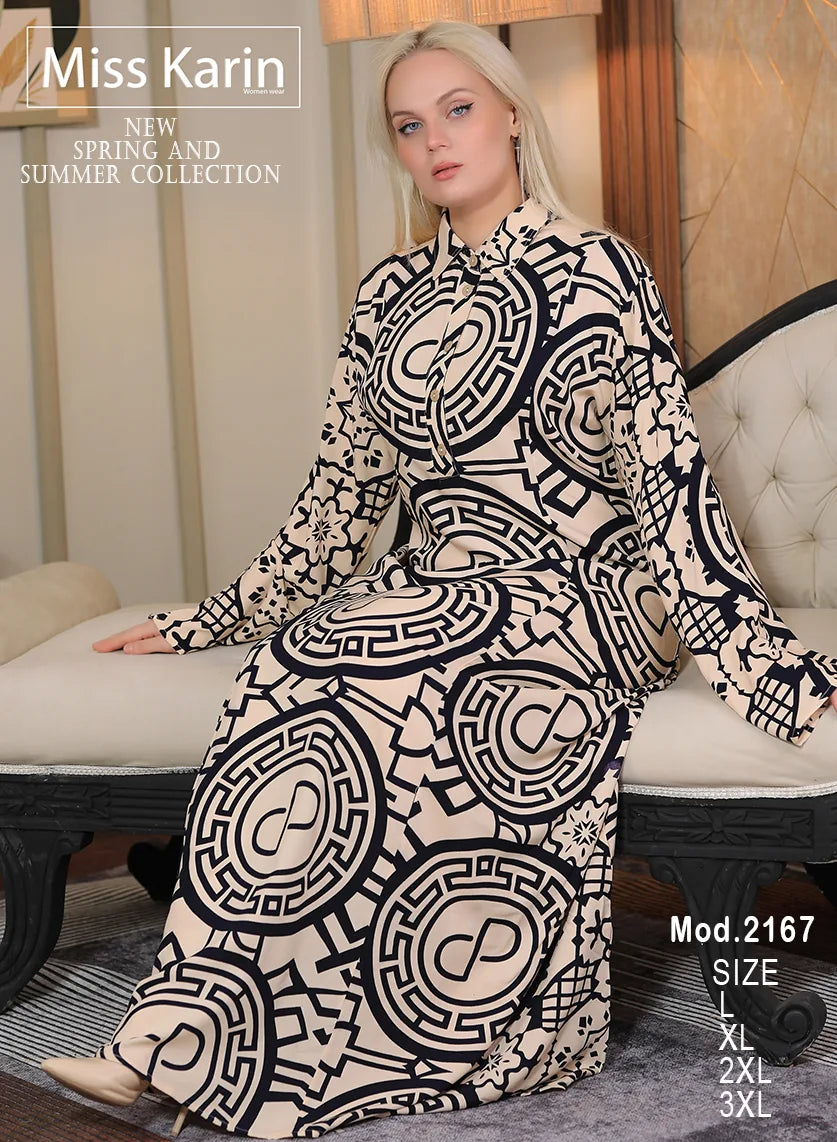 Woman wearing a black and white patterned dress sitting on a couch with 'Miss Karin' branding.