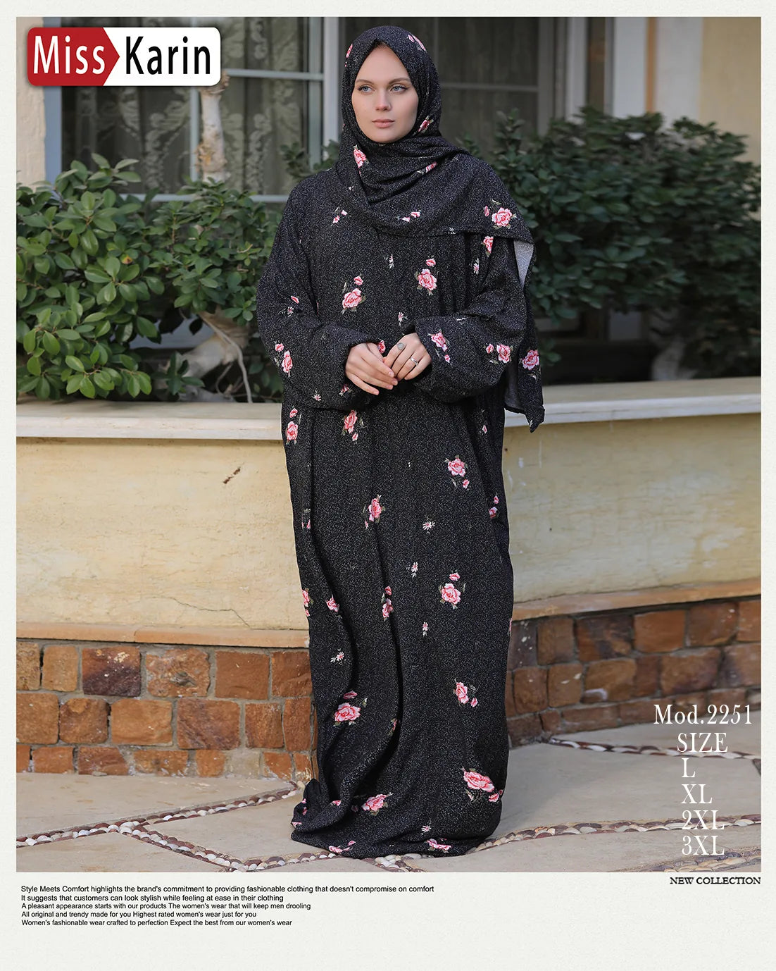 Woman wearing a black outfit with pink floral patterns sitting outdoors.