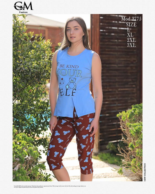 Woman wearing a blue sleeveless top and brown pants with teddy bear design outdoors.