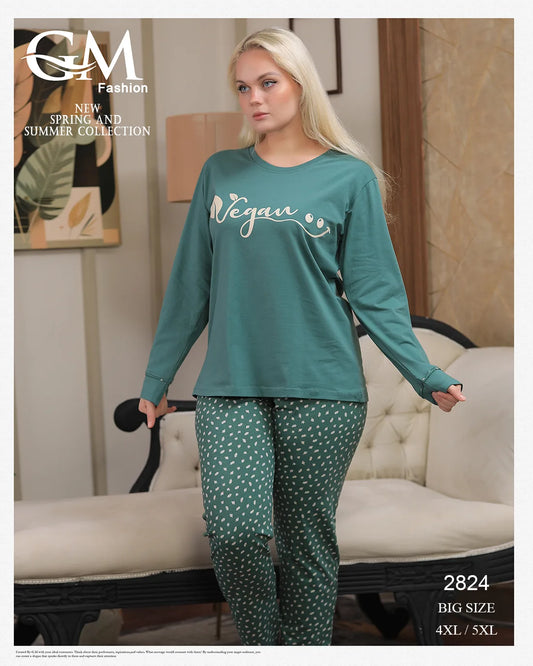 Woman wearing a teal 'Vegan' shirt and patterned pants in a living room setting.