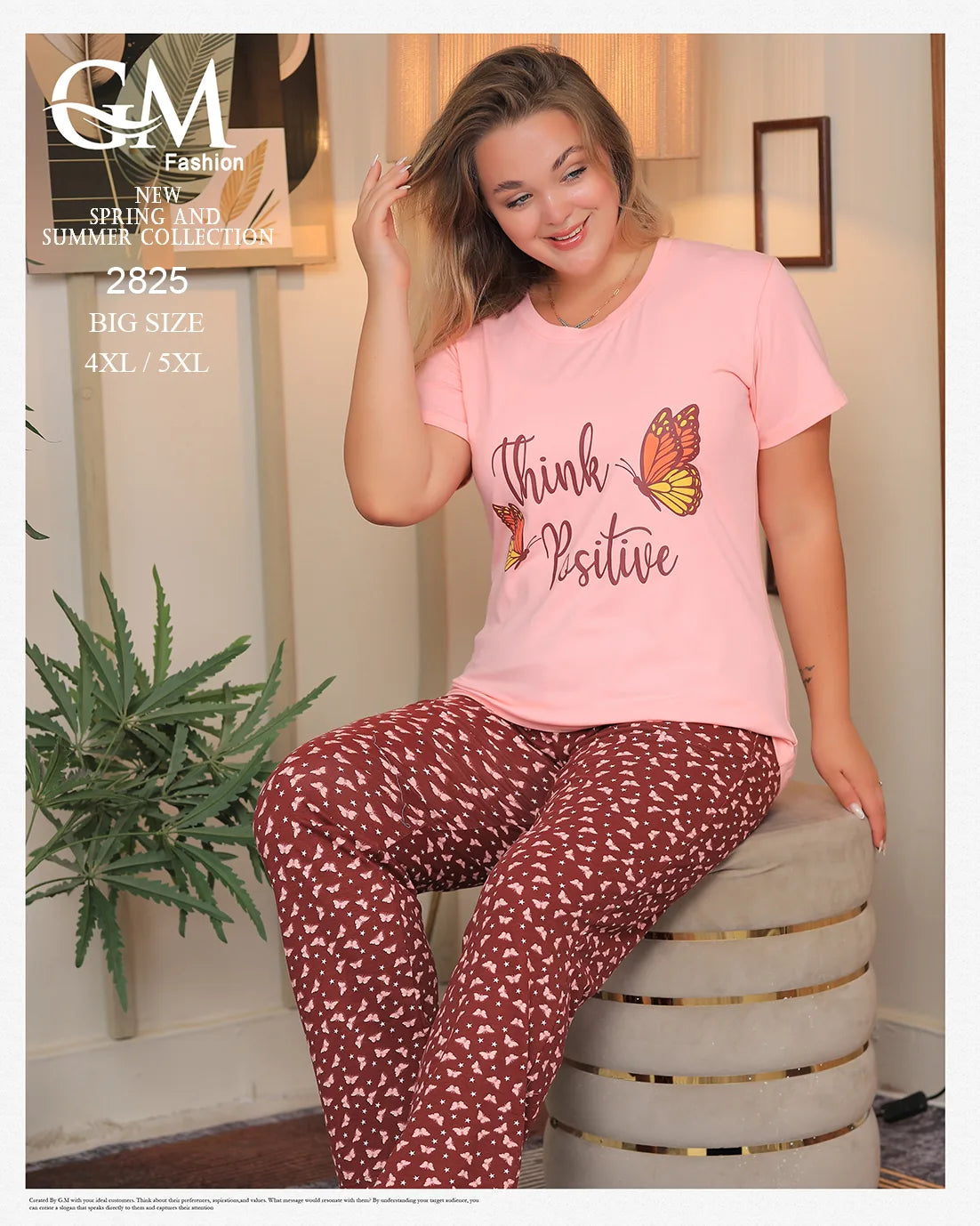 Woman wearing a pink 'Think Positive' t-shirt and maroon patterned pants sitting on a stool indoors.