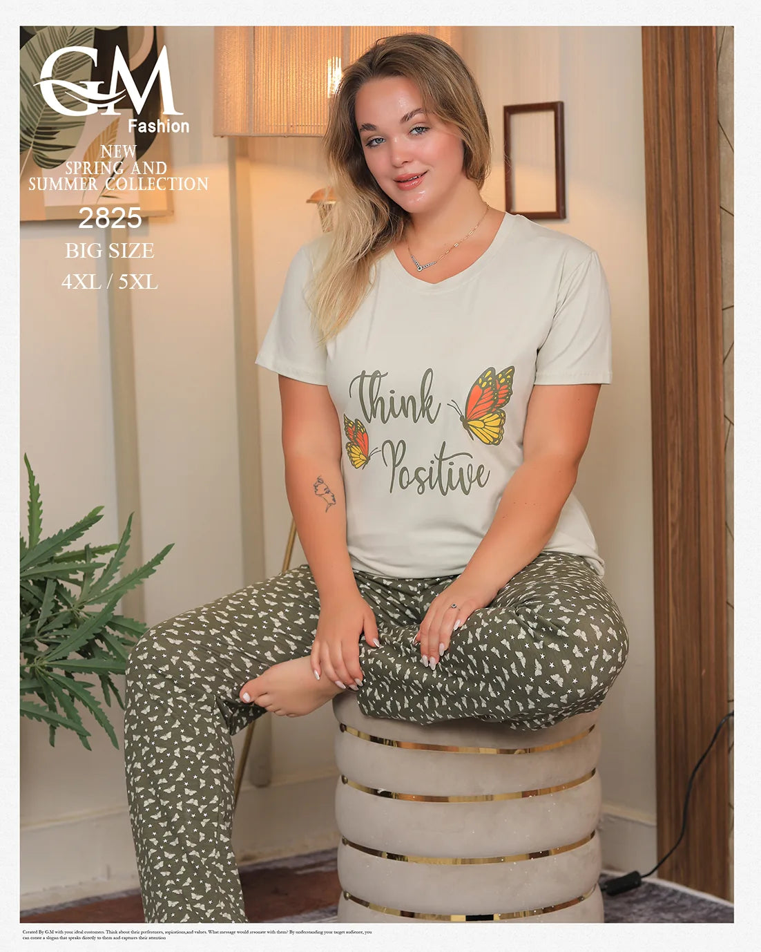 Woman wearing a 'Think Positive' t-shirt sitting on a stool indoors.