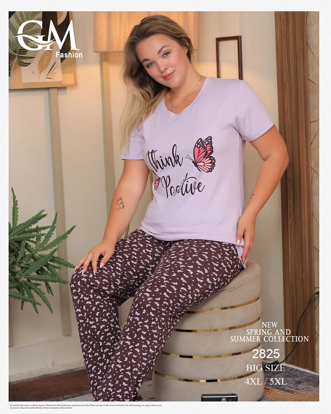 Woman wearing a light purple t-shirt with a butterfly design and text, sitting on a chair indoors.