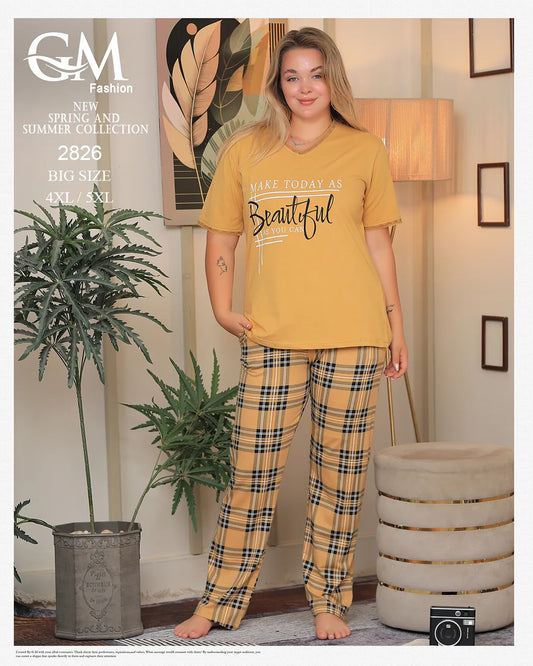 Woman wearing a yellow t-shirt and plaid pants in a home setting with decor elements.