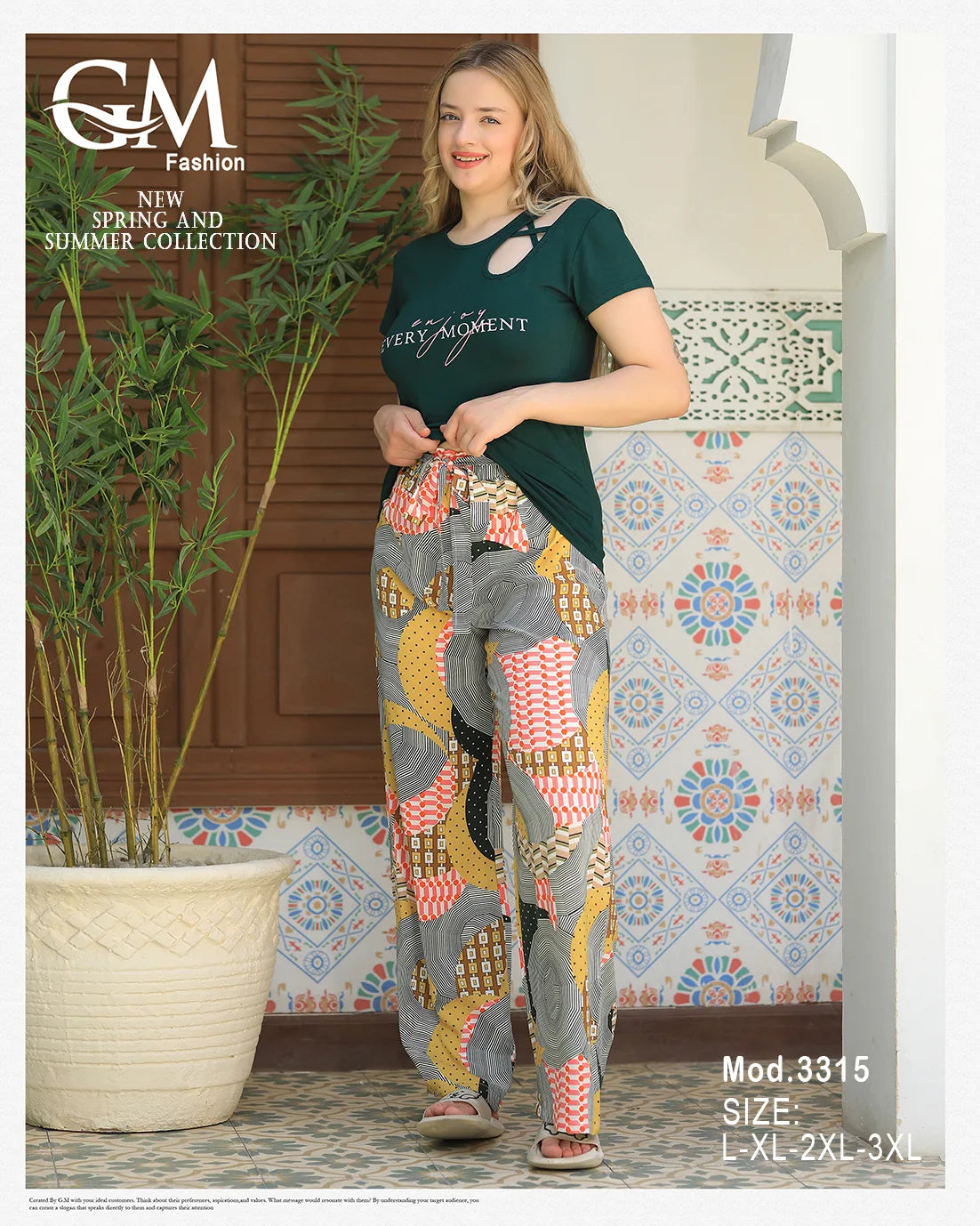 Woman wearing a green top and patterned pants standing in front of a decorative wall with 'GM Fashion' branding.