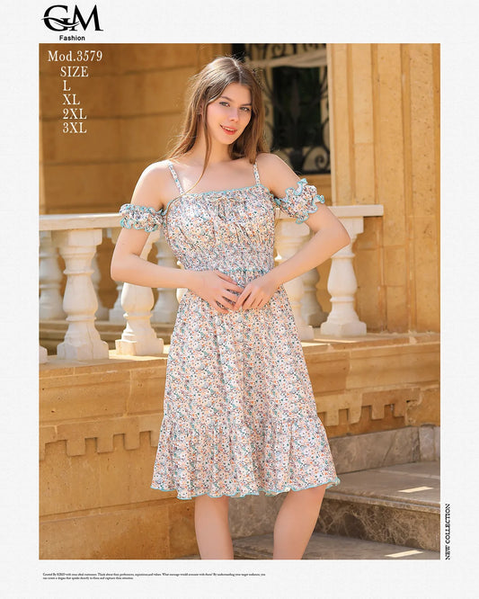 Woman wearing a floral dress standing outdoors with a stone wall and columns in the background.