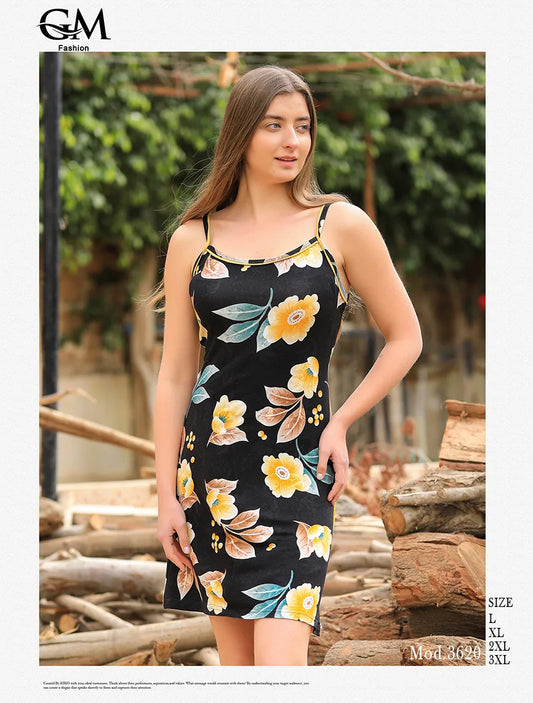 Woman wearing a floral dress standing outdoors with greenery in the background