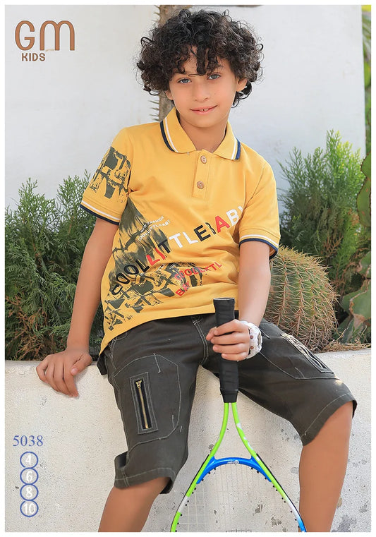Child wearing a yellow polo shirt with text and dark shorts, holding a tennis racket outdoors.