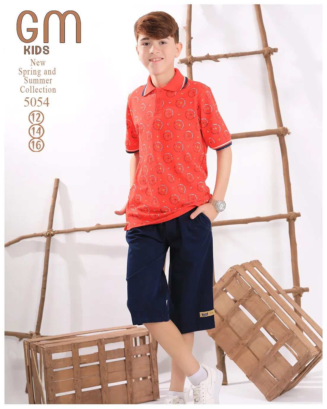 Child wearing a red patterned shirt and navy shorts standing next to a wooden ladder and crates.