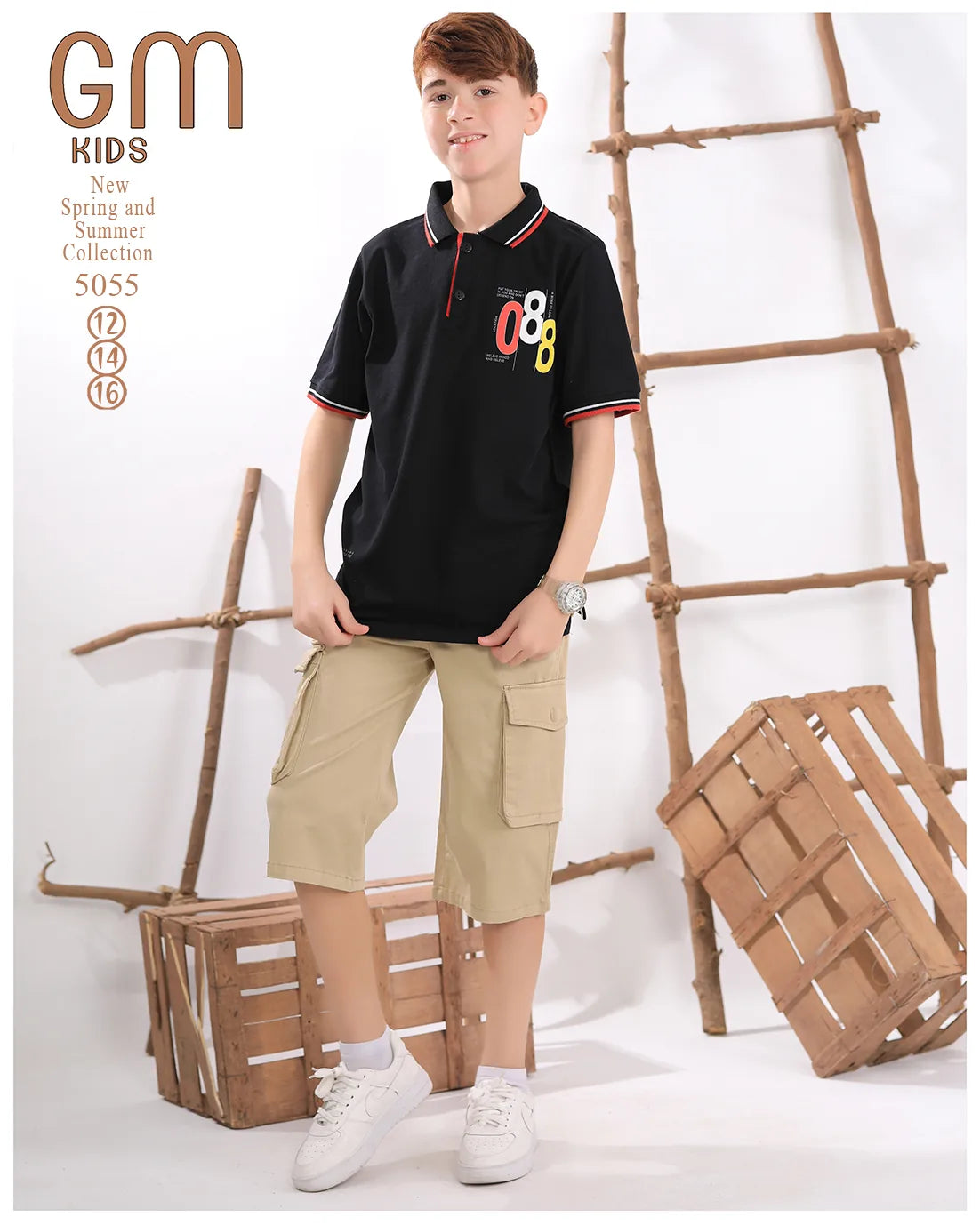Child wearing a black polo shirt with '08' design and beige shorts, standing against a white background with wooden crates and a ladder.