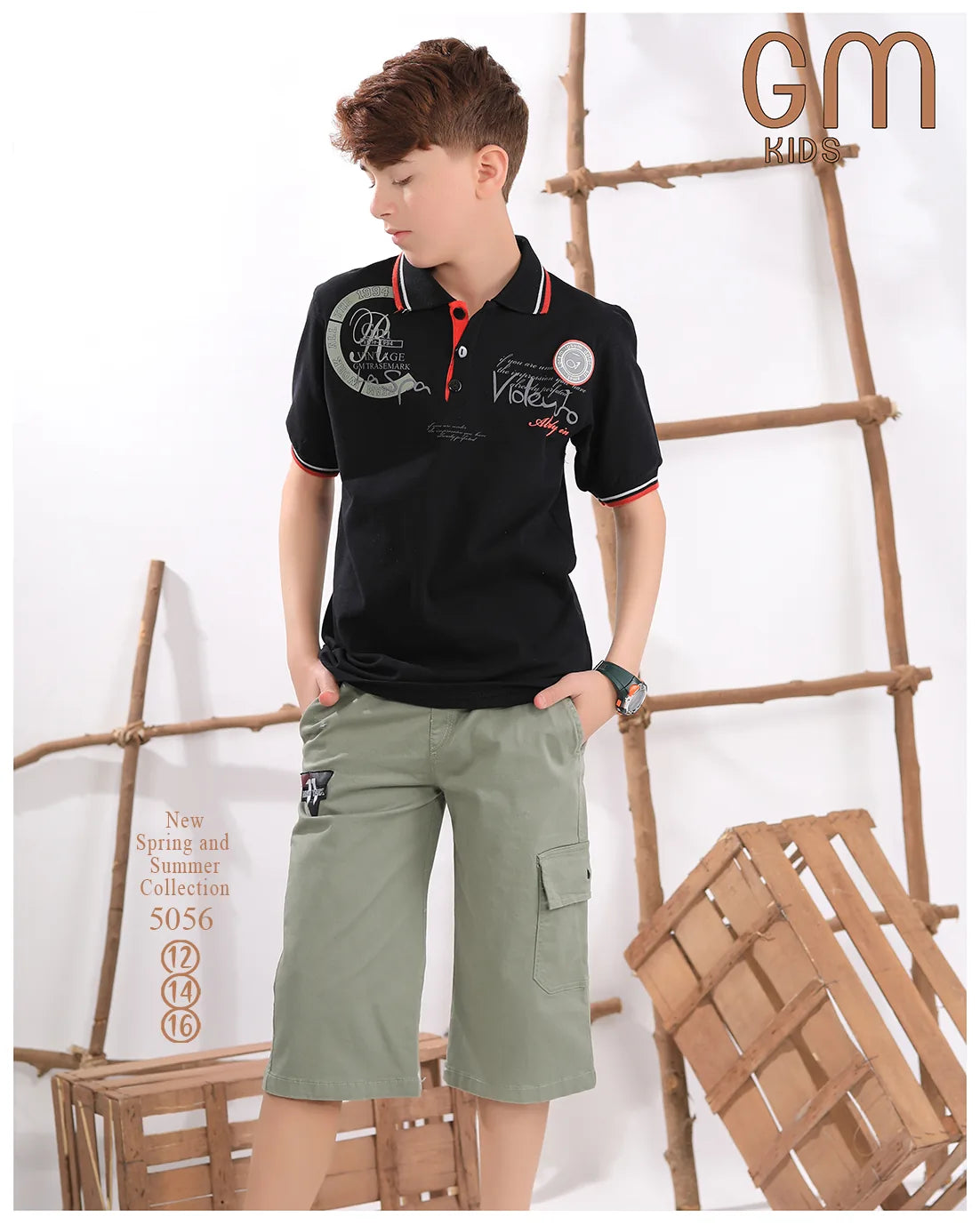 Child wearing a black polo shirt and green shorts with wooden crates in the background, featuring 'GM Kids' branding.