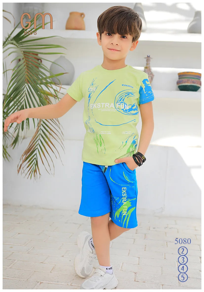 Child wearing a green and blue outfit with 'cm' branding in the corner.