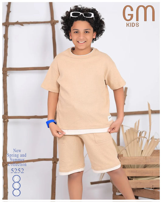 Child wearing a beige outfit with 'GM Kids' branding in the corner.