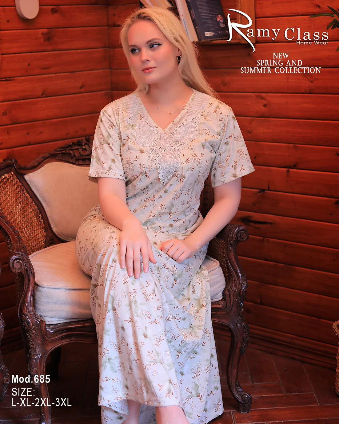 Woman sitting on a chair wearing a floral dress with 'Ramy Class' branding.