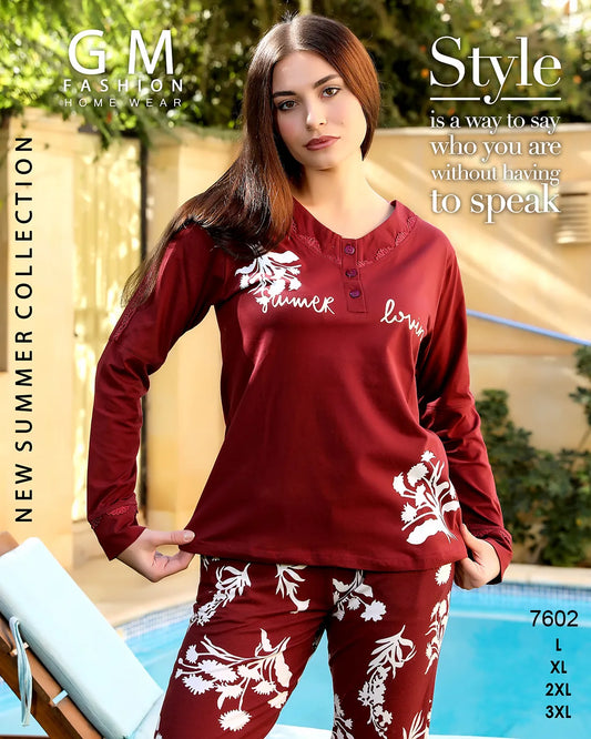 Woman wearing a red long-sleeve top and pants with floral patterns by a pool, with 'GM Fashion Home Wear' branding.