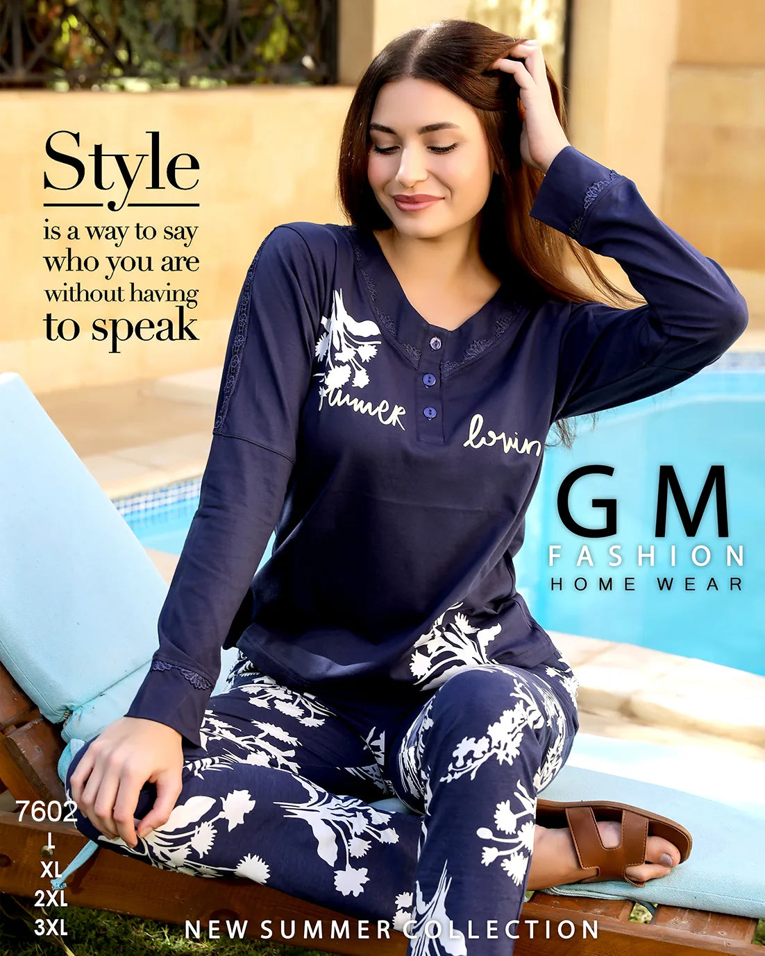Woman wearing navy blue pajama set with floral patterns by GM Fashion, sitting by a pool.