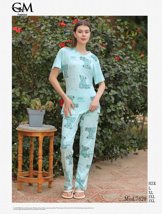 Woman wearing a light blue pajama set with a floral pattern in an outdoor setting.