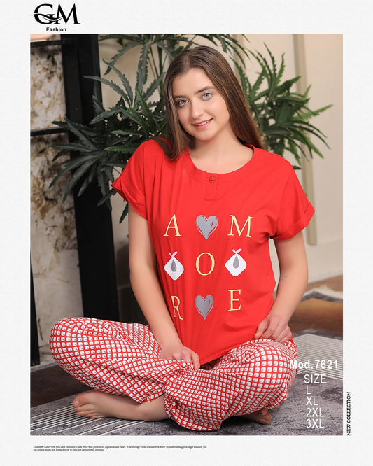 Woman wearing a red shirt with 'I love you' text and red checkered pants sitting on the floor.